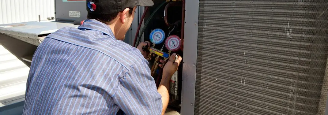 HVAC technician servicing a condenser unit in Grapevine