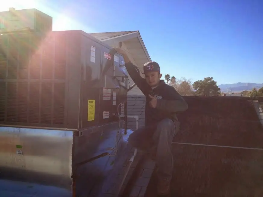 HVAC technician performing HVAC Inspection on a rooftop unit in Grapevine
